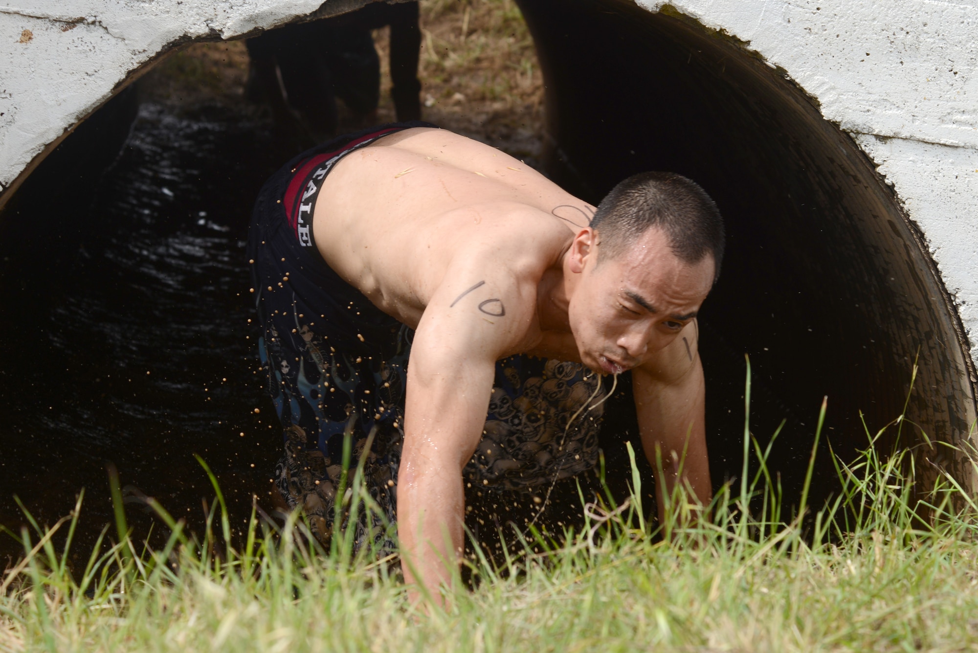 An Ultimate Dirty Dash 3 participant emerges from “The Tunnel of Doom” May 18, 2013, at Incirlik Air Base, Turkey. Several teams competed in the race through 21 different stations, covering themselves in mud throughout the 5K course. (U.S. Air Force photo by Tech. Sgt. Dallas Edwards/Released)