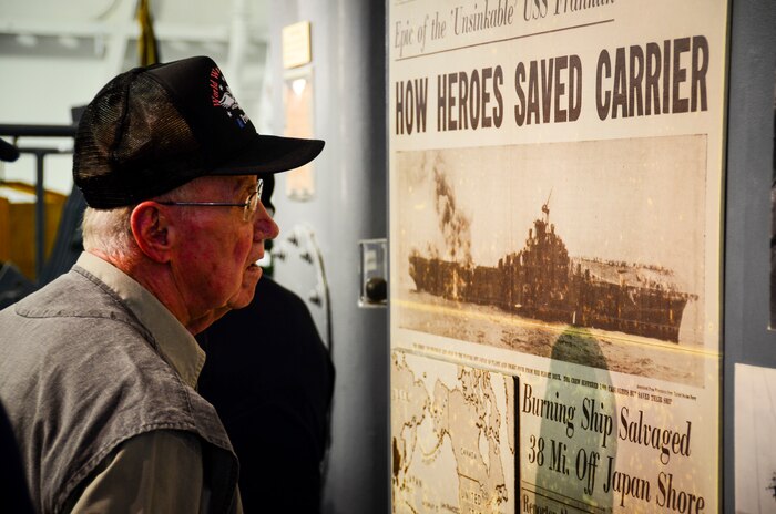 A World War II veteran reads a newspaper posted in the USS Franklin (CV 13) exhibit aboard the USS Yorktown (CV 10) May 17, 2013, at Patriots Point Naval and Maritime Museum, Mount Pleasant, S.C. More than 20 of the remaining crewmembers of the Franklin gathered for a final reunion. In their honor, Patriots Point hosted a series of events and educational programs throughout the day to allow the public an opportunity to speak with and hear from the veterans. (U.S. Air Force photo/Staff Sgt. Anthony Hyatt)