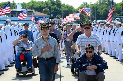 Surviving crewmembers of the USS Franklin (CV 13) walk toward the USS Yorktown (CV 10) for their final reunion May 17, 2013, at Patriots Point Naval and Maritime Museum in Mt. Pleasant, S.C. On March 19, 1945, the Franklin was hit by two Japanese bombs, which ignited armed aircraft and triggered a gasoline vapor explosion devastating the hangar bay, killing more than 800 Sailors and wounding nearly 500. (U.S. Air Force photo/Staff Sgt. Anthony Hyatt) 