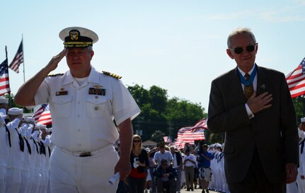 Navy Capt. Thomas Bailey, Joint Base Charleston deputy commander, and retired U.S. Marine Corps Maj. Gen. Jim Livingston, walk down the pier toward the USS Yorktown (CV 10) May 17, 2013, at Patriots Point Naval and Maritime Museum, Mount Pleasant, S.C., as surviving crewmembers of the USS Franklin (CV-13), gathered at Patriots Point for their final reunion. In honor of the historic event, Patriots Point hosted a series of events and educational programs throughout the day to allow the public an opportunity to speak with and hear from veterans. More than 20 remaining crewmembers of the Franklin attended the reunion. (U.S. Air Force photo/Staff Sgt. Anthony Hyatt)