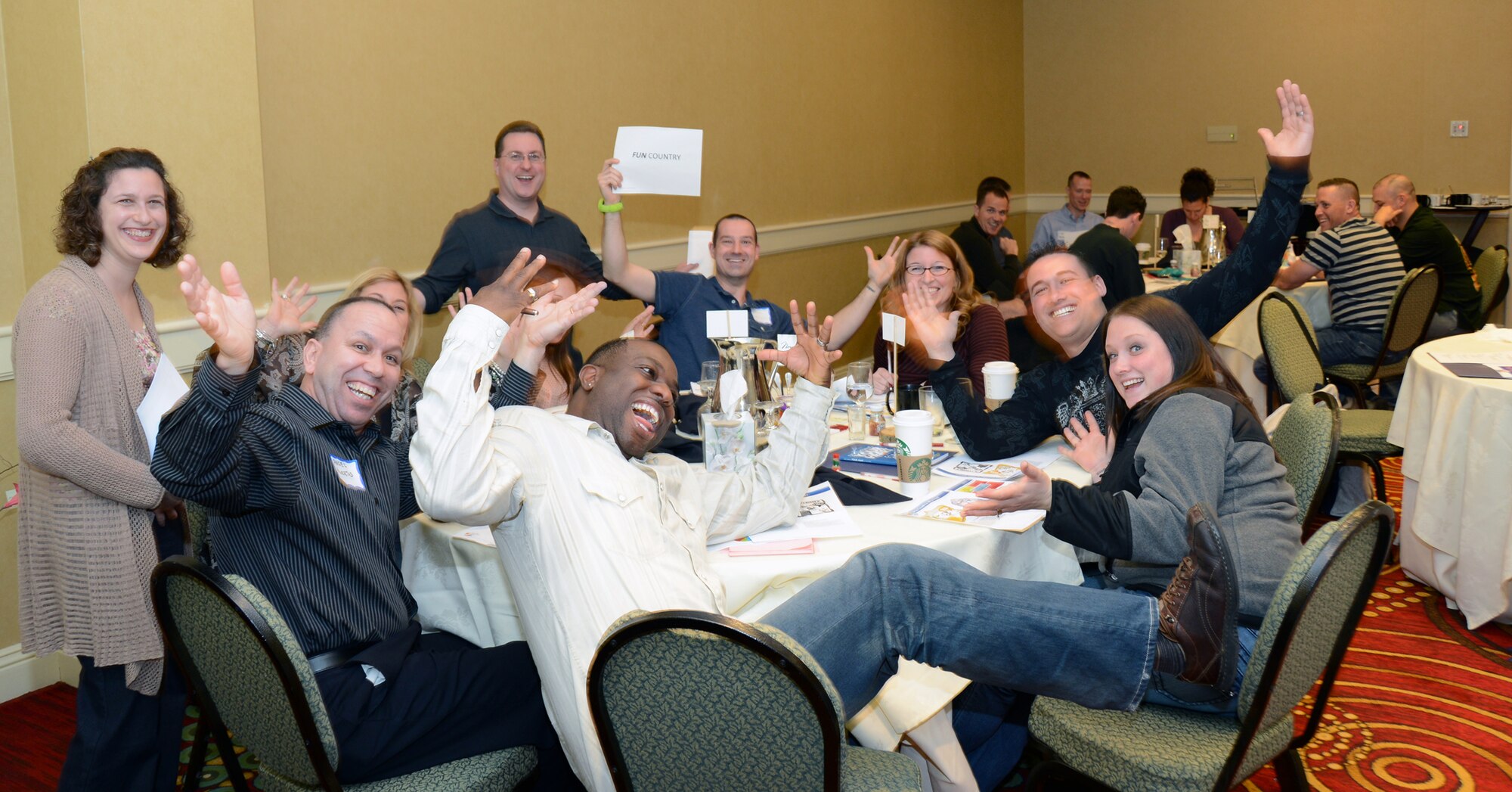 Participants of the 103rd Airlift Wing Chaplain’s office Strong Bonds event show the camera how fun they are, which was part of the personality assessments given during the event which was held at the Mystic Marriott  Hotel and Spa located in Groton, Conn., April 12, 2013. (U.S. Air National Guard photo by Senior Airman Jennifer Pierce/Released)