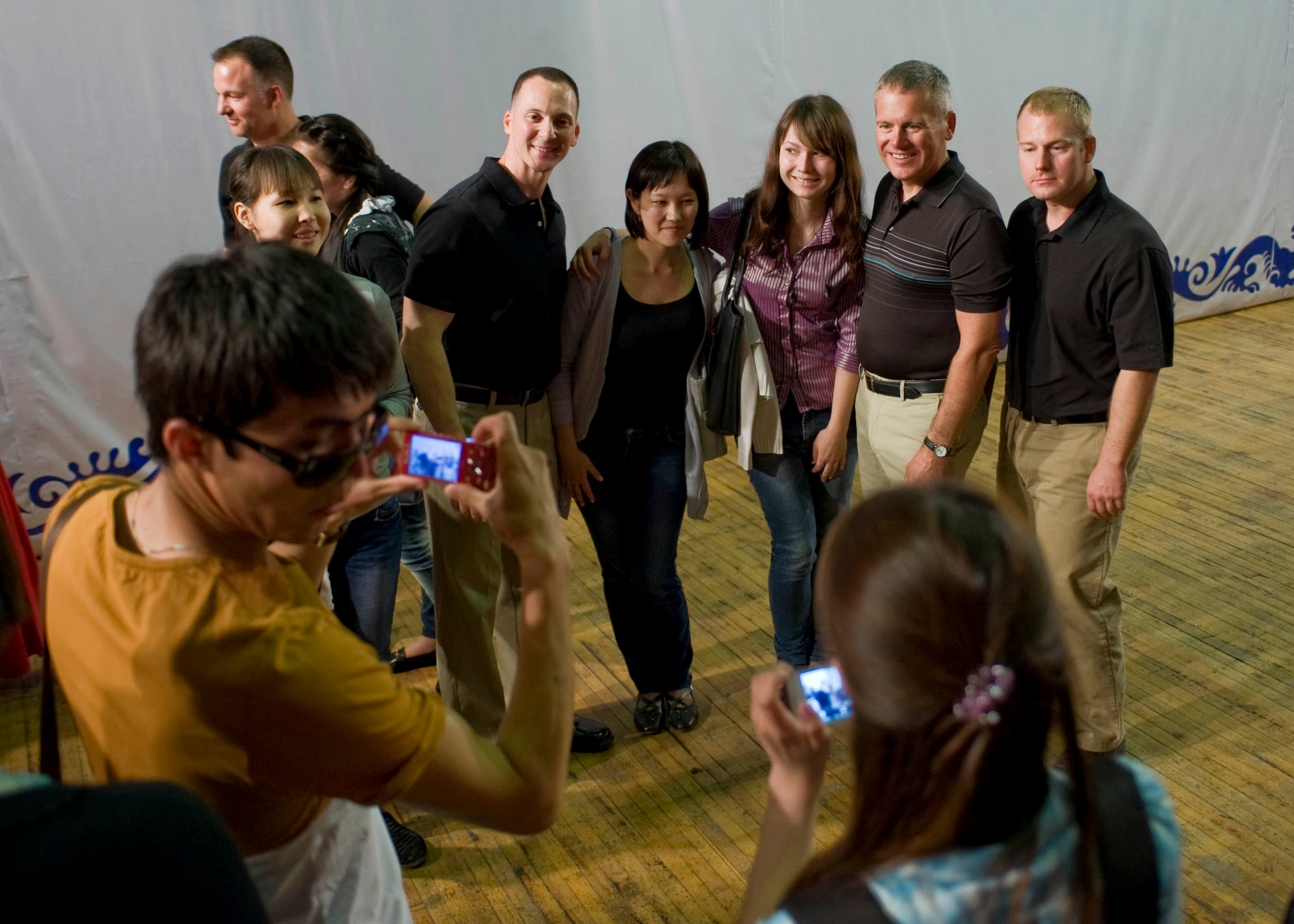 Members from Vector, the U.S. Air Forces Central Command band, pose for photos with students from the Bishkek Humanities University, May 2, 2013, in Bishkek, Kyrgyzstan. "We've had great reactions here in Kyrgyzstan," said Master Sgt. Matt Murray, the bassist for the band. (U.S. Air Force photo/Staff Sgt. Stephanie Rubi) 