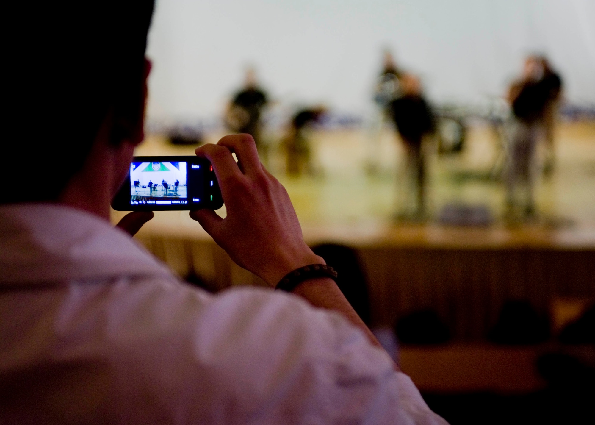 A student from Bishkek Humanities University takes a photo during a musical performance by the U.S. Air Forces Central Command band, Vector, May 2, 2013, in Bishkek, Kyrgyzstan. The band performed a variety of rock songs from the 1970s to current hits. (U.S. Air Force photo/Staff Sgt. Stephanie Rubi)