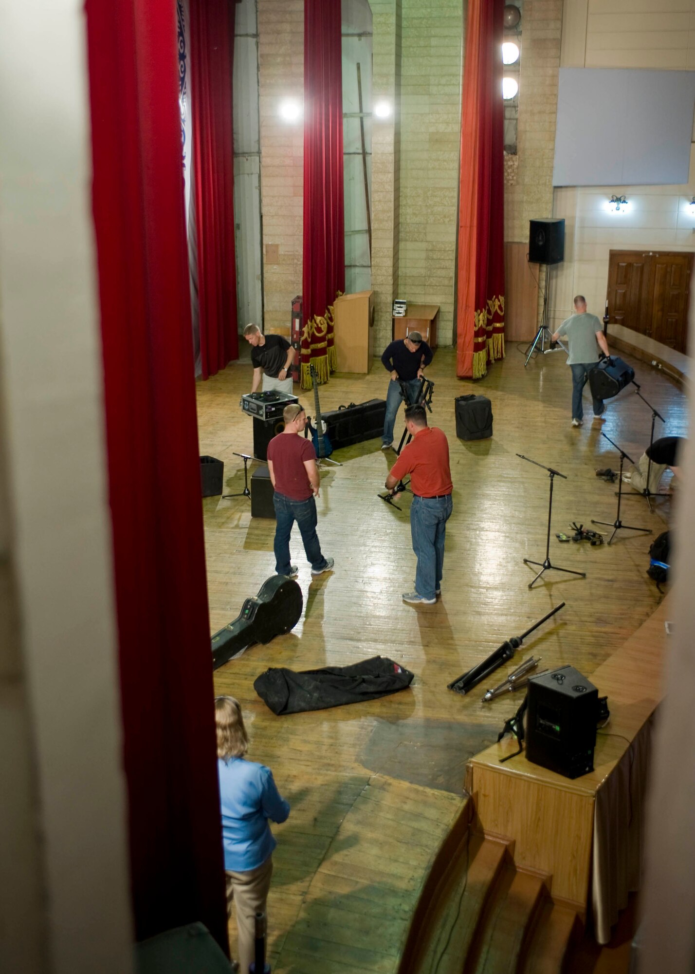 Members from the U.S. Air Forces Central Command band, Vector, set-up equipment prior to a performance at the Bishkek Humanities University May 2, 2013, in Bishkek, Kyrgyzstan. The band toured Kyrgyzstan and performed for a variety of audiences in the area. (U.S. Air Force photo/Staff Sgt. Stephanie Rubi)