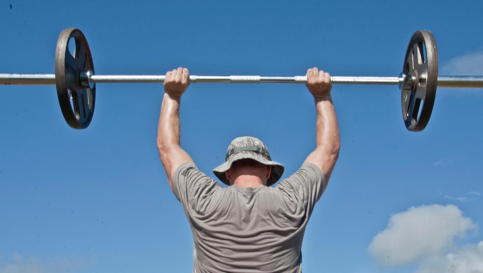 1st Lt. Brian Slater, 36th Security Forces Squadron assistant operations officer, performs a power clean during the Strongman Competition at Andersen Air Force Base, Guam, May 15, 2013. The Strongman Competition was held in honor of National Police Week which occurs each year during the week of May 15 in recognition of the service and sacrifice of members of U.S. law enforcement agencies. (U.S. Air Force photo by Airman 1st Class Adarius Petty/Released)