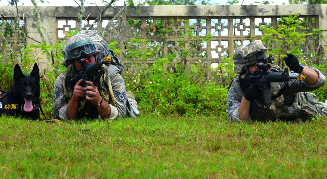 Two students of the Pacific Regional Training Center’s basic security operations course provide suppressive fire during an urban warfare scenario at Andersen South, Guam, May 17, 2013. The PRTC trains frontline defenders from all bases assigned to Pacific Air Forces on U. S. Central Command and regional training requirements so they can deploy as well as utilize trained skills at their home stations. (U.S. Air Force photo by Staff Sgt. Benjamin Wiseman/Released)
