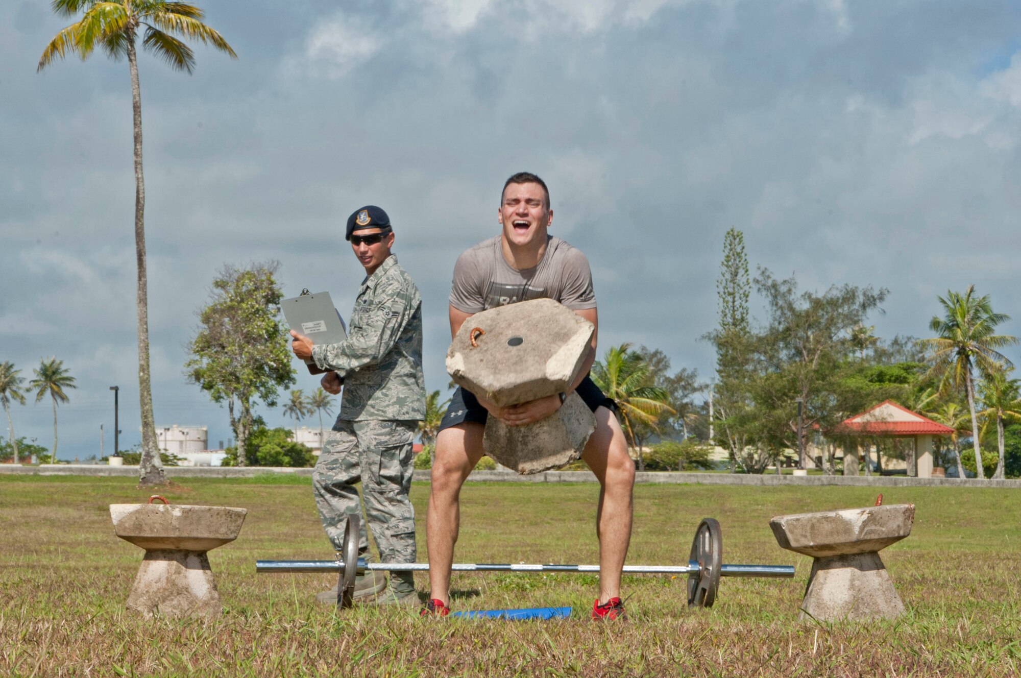 Airman 1st Class Cody Rother, 36th Security Forces Squadron patrolman, lifts a cement block during the Strongman Competition at Andersen Air Force Base, Guam, May 15, 2013. The Strongman Competition was held in honor of National Police Week which occurs each year during the week of May 15 in recognition of the service and sacrifice of members of U.S. law enforcement agencies. (U.S. Air Force photo by Airman 1st Class Adarius Petty/Released)