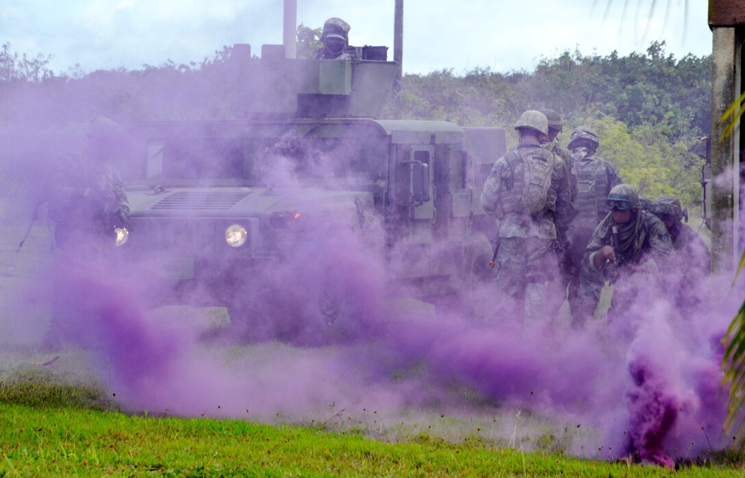 Students work through an urban warfare scenario during the basic security operations course at Andersen South, Guam, May 17, 2013. Thirty-one defenders from Kadena Air Base, Japan, and Eielson Air Force Base, Alaska participated in the 17-day course to enhance their mission skills for deployment, as well as use the skills to train other defenders at their home stations. (U.S. Air Force photo by Staff Sgt. Benjamin Wiseman/Released)