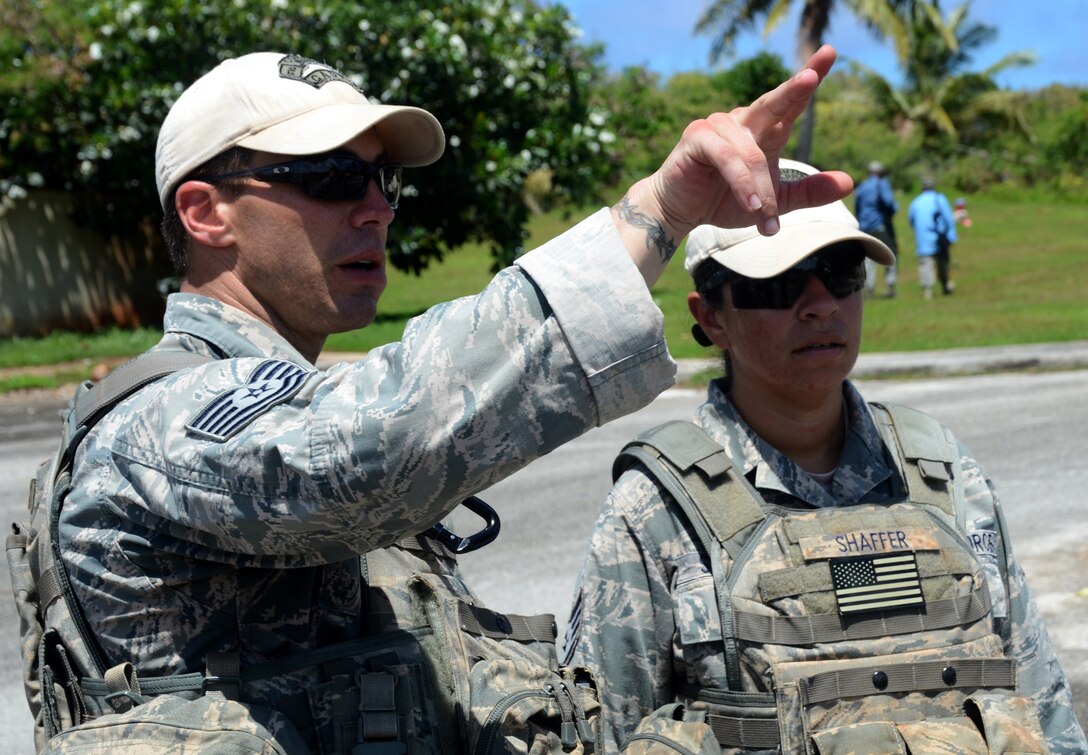 Tech. Sgt. J Sanders, 736th Security Forces Squadron Commando Warrior Flight cadre, discusses scenario plans with Staff Sgt. Brissa Shaffer, 736th SFS Commando Warrior cadre, during the basic security operations course at Andersen South, Guam, May 17, 2013. Thirty-one defenders from Kadena Air Base, Japan, and Eielson Air Force Base, Alaska, participated in the 17-day course to enhance their mission skills for deployment, as well as use the skills to train other defenders at their home stations. (U.S. Air Force photo by Staff Sgt. Benjamin Wiseman/Released)