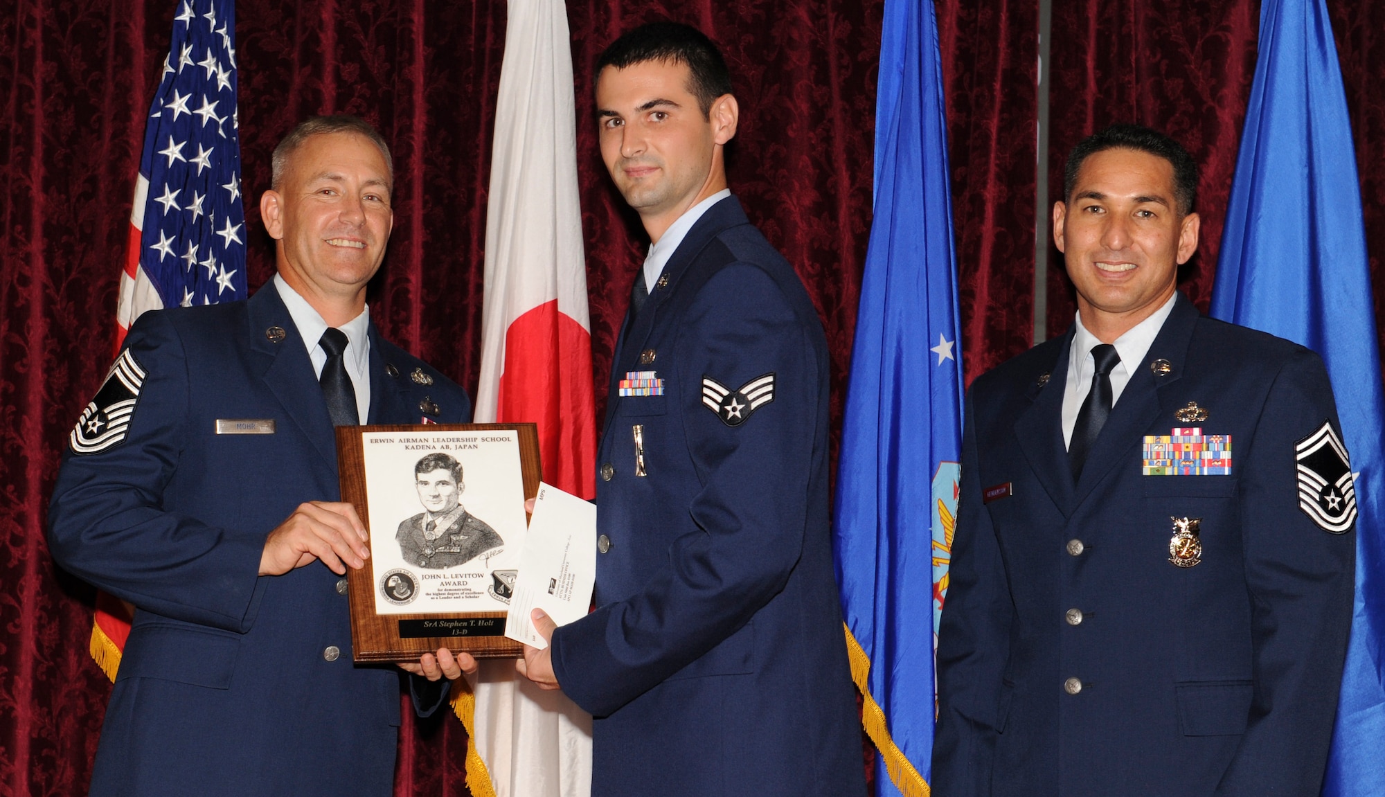 U.S. Air Force Senior Airman Stephen Holt, from the 18th Maintenance Operations Squadron, receives the Levitow Award during his Airman Leadership School graduation on Kadena Air Base, Japan, May 17, 2013. This award, which is named after the Medal of Honor recipient John L. Levitow, recognizes Holt as the top of his class in a combined role as leader and scholar. (U.S. Air Force photo by Airman 1st Class Keith James/Released)