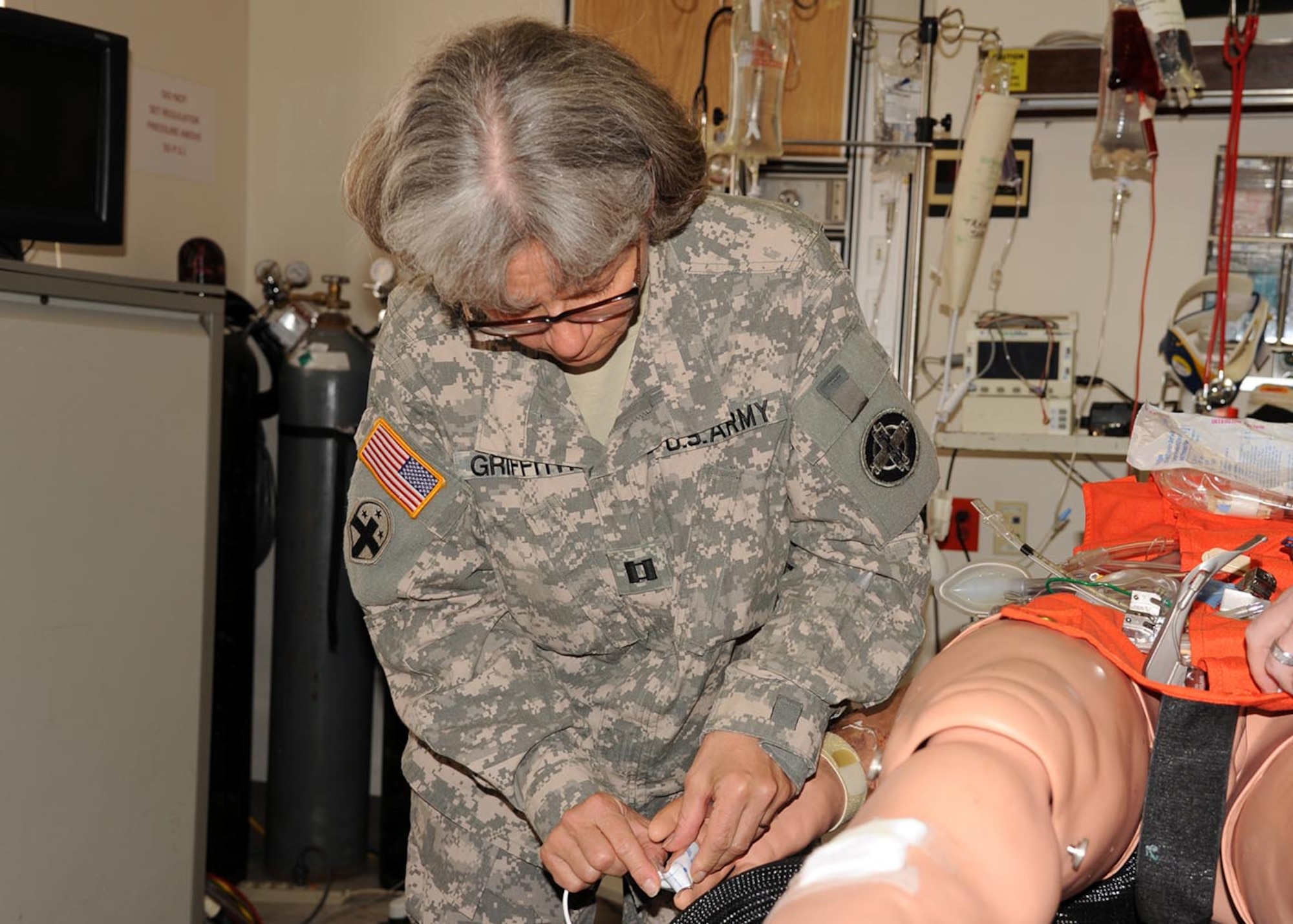 Capt. Holly Griffith places a pulse monitor on a mannequin during a critical care simulation exercise April 24 at the Wilford Hall Ambulatory Surgical Center, Joint Base San Antonio- Lackland, Texas. The training is part of the pre-deployment Battlefield Nursing Course designed to teach current trauma care concepts to U.S. Air Force, Army, Navy nurses and technicians, as well as foreign nationals. The majority of participants are reservists. Griffith is an operating room nurse with the 345th Combat Support Hospital, Naval Air Station, Jacksonville, Fla. (U.S. Air Force photo/Senior Airman Courtney Moses)
