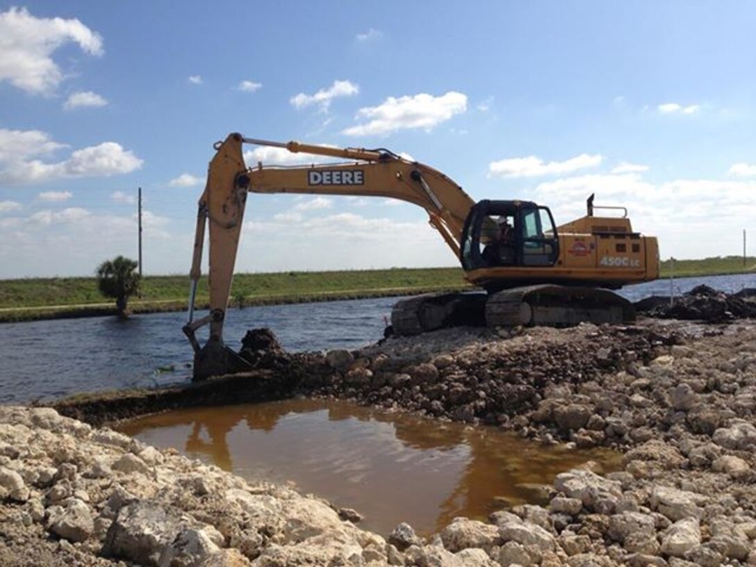 The old Tamiami Trail roadway was broken through on May 15 during roadway removal efforts as part of the Tamiami Trail Modifications project in Miami, Fla. The road has served as a longstanding physical barrier, preventing water from flowing into Everglades National Park. While there is still much more work to be done on the project, removal of the one-mile section of roadway will bring the project one step closer to completion. For additional information on the project visit: http://bit.ly/TamiamiTrail