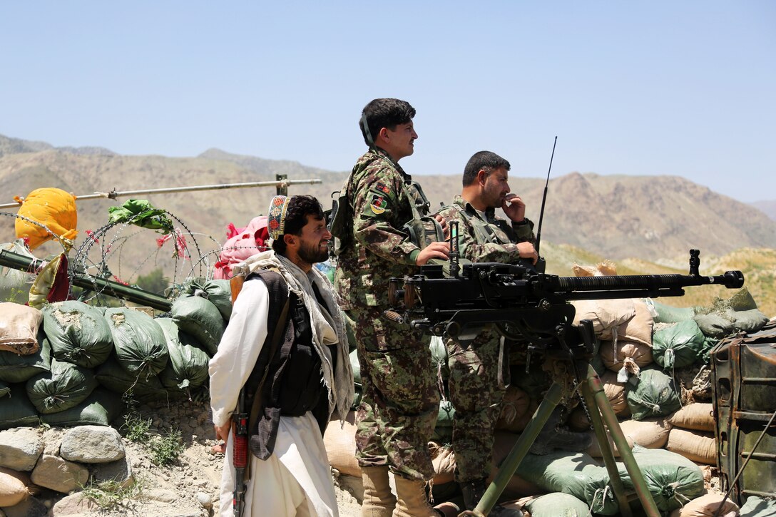 Afghan army soldiers scan the area from an operation post during a mission outside the Hesarak village of Nangarhar province, Afghanistan, May 15, 2013.