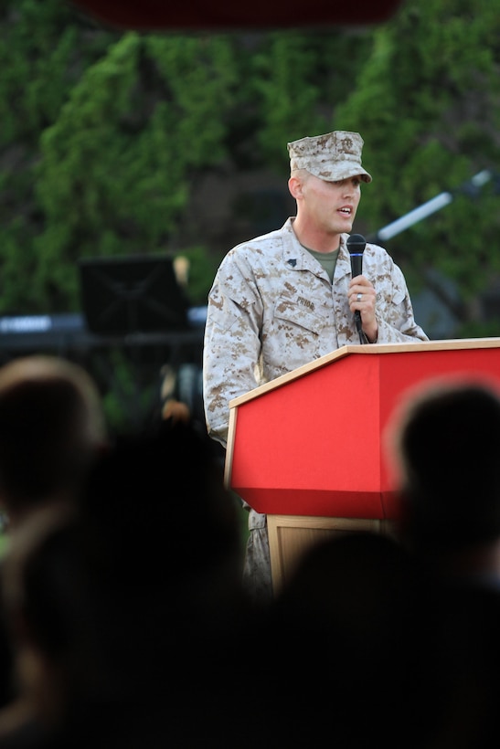 Sgt. Christopher Prior, a 3rd Marine Aircraft Wing noncommissioned officer and Cedar Rapids, Iowa native, speaks to Marines, sailors, spouses and families during an evening colors ceremony honoring military spouses aboard Marine Corps Air Station Miramar, Calif., May 21. During the ceremony Prior spoke about what it means to be a spouse in the military before introducing the guest of honor, who has spent 41 years as a military spouse.
