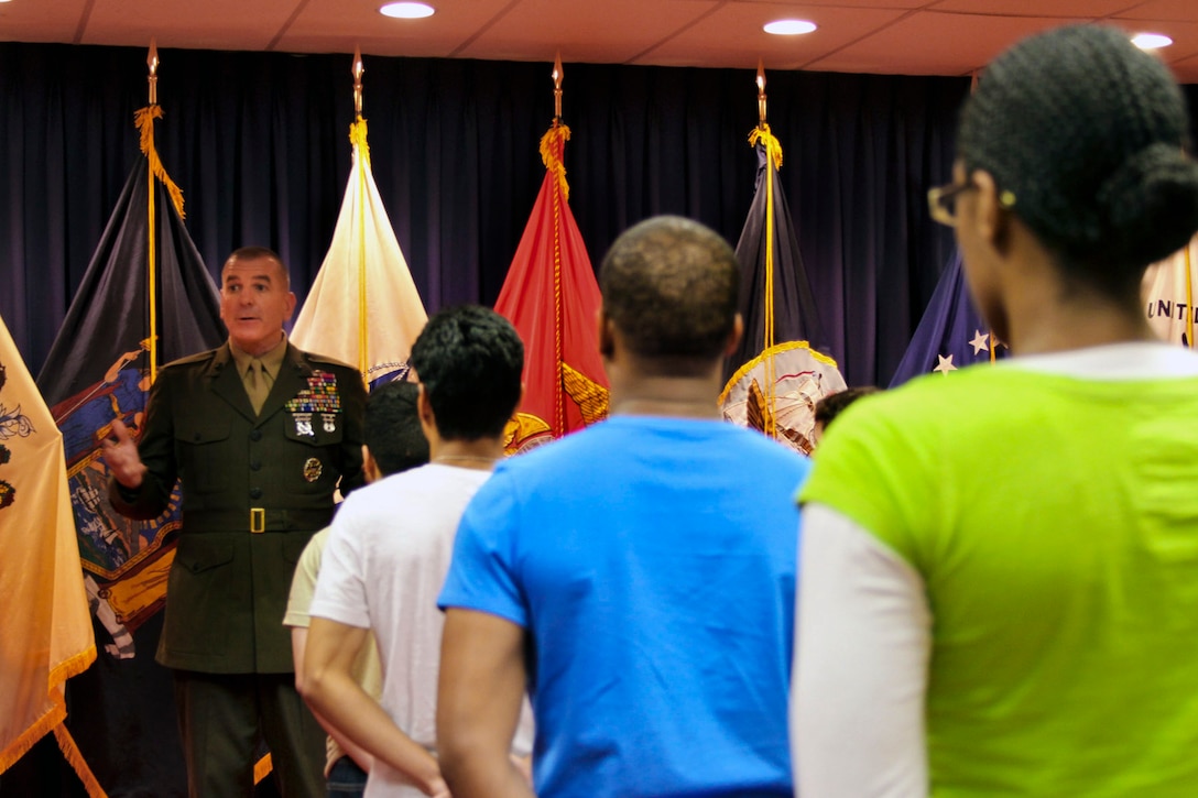 Marine Corps Sgt. Maj. Bryan B. Battaglia, senior enlisted advisor to the chairman of the Joint Chiefs of Staff, left, talks to recruits during his tour of the New York Military Entrance Processing Station, at Fort Hamilton, N.Y., May 21, 2013. Battaglia administered the oath of enlistment during his visit.