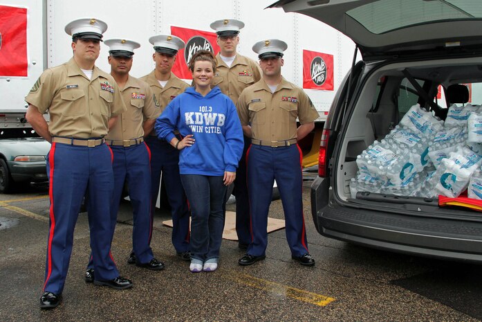 101.3 KDWB radio personality Falen Bonsett accepts a $200 water donation for H2OK from the Marines with Recruiting Substation Roseville May 22. KDWB, Rainbow Foods and 101 Transport Inc. coordinated the event to bring relief to those affected by recent tornadoes in Oklahoma. Donations will be shipped via semi to Moore, Okla., on Thursday. For additional imagery from the event, visit www.facebook.com/rstwincities. 