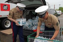 Recruiting Substation Roseville's Sgts. Kenneth Koitzsch and Phillip Sze unload a $200 water donation for H2OK May 22. Radio station 101.3 KDWB, Rainbow Foods and 101 Transport Inc. coordinated the event to bring tornado relief to Oklahoma. Donations will be shipped via semi to Moore, Okla., on Thursday. For additional imagery from the event, visit www.facebook.com/rstwincities.