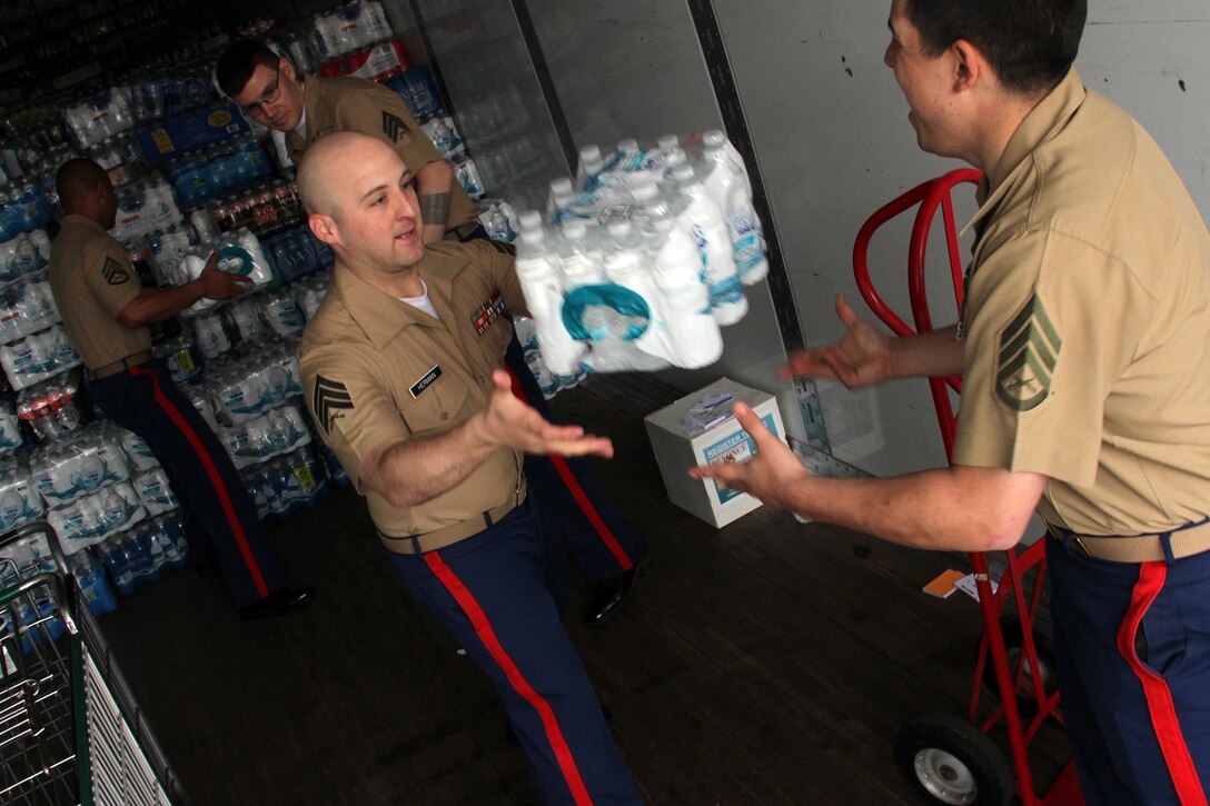 Marines with Recruiting Substation Roseville help unload a pallet of water bottles after dropping off a $200 donation for H2OK May 22. Radio station 101.3 KDWB, Rainbow Foods and 101 Transport Inc. coordinated the event for Oklahoma tornado relief. Donations will be shipped via semi to Moore, Okla., on Thursday. For additional imagery from the event, visit www.facebook.com/rstwincities.
