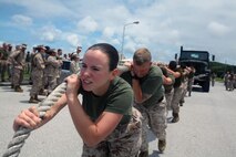 Cpl. Cynthia S. Raiche leads her team during a 7-ton truck-pull event at Roberts Field on Camp Kinser on May 14 as part of the 3rd Maintenance Battalion "wrench-off." The event was designed so the battalion's five companies could compete against each other in various challenges such as: a Humvee pit crew relay, weapons systems disassembly and reassembly relay, log toss relay and the truck-pull. Raiche is a maintenance management specialist with Engineer Maintenance Company, 3rd Maintenance Bn., Combat Logistics Regiment 35, 3rd Marine Logistics Group, III Marine Expeditionary Force. 