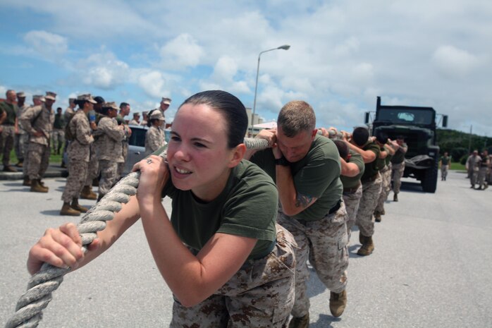 Cpl. Cynthia S. Raiche leads her team during a 7-ton truck-pull event at Roberts Field on Camp Kinser on May 14 as part of the 3rd Maintenance Battalion "wrench-off." The event was designed so the battalion's five companies could compete against each other in various challenges such as: a Humvee pit crew relay, weapons systems disassembly and reassembly relay, log toss relay and the truck-pull. Raiche is a maintenance management specialist with Engineer Maintenance Company, 3rd Maintenance Bn., Combat Logistics Regiment 35, 3rd Marine Logistics Group, III Marine Expeditionary Force. 