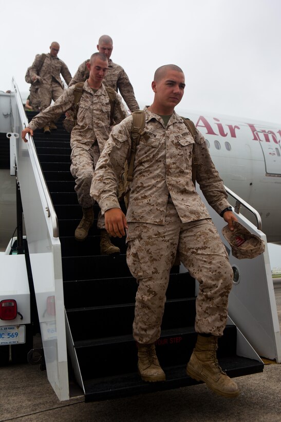 Marines with 2nd Battalion, 4th Marines, 5th Marine Regiment, 1st Marine Division, debark the plane after arriving here, May 22. The Marines of 2/4 arrived in Okinawa to become the 31st Marine Expeditionary Unit’s new battalion landing team, replacing 1st Battalion, 5th Marine Regiment, after their six-month tour with the MEU. The 31st MEU is the only continuously forward-deployed MEU and is the Marine Corps’ force in readiness in the Asia-Pacific region.