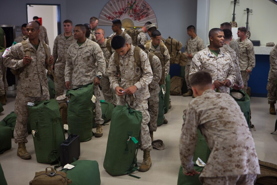 Marines with 2nd Battalion, 4th Marines, 5th Marine Regiment, 1st Marine Division, have their gear inspected at customs following their arrival here, May 22. The Marines of 2/4 arrived in Okinawa to become the 31st Marine Expeditionary Unit’s new battalion landing team, replacing 1st Battalion, 5th Marine Regiment, after their six-month tour with the MEU. The 31st MEU is the only continuously forward-deployed MEU and is the Marine Corps’ force in readiness in the Asia-Pacific region.