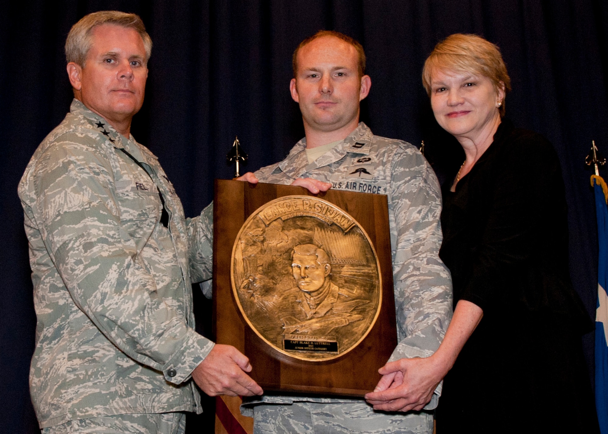 Lt. Gen. Eric Fiel, Air Force Special Operations Command commander, presents Capt. Blake Lutrell, 21st Special Tactics Squadron officer, Pope Field, N.C., with the Sijan award at the King Auditorium on Hurlburt Field, Fla., May 22, 2013. (U.S. Air Force photo by Senior Airman Krystal M. Garrett) 