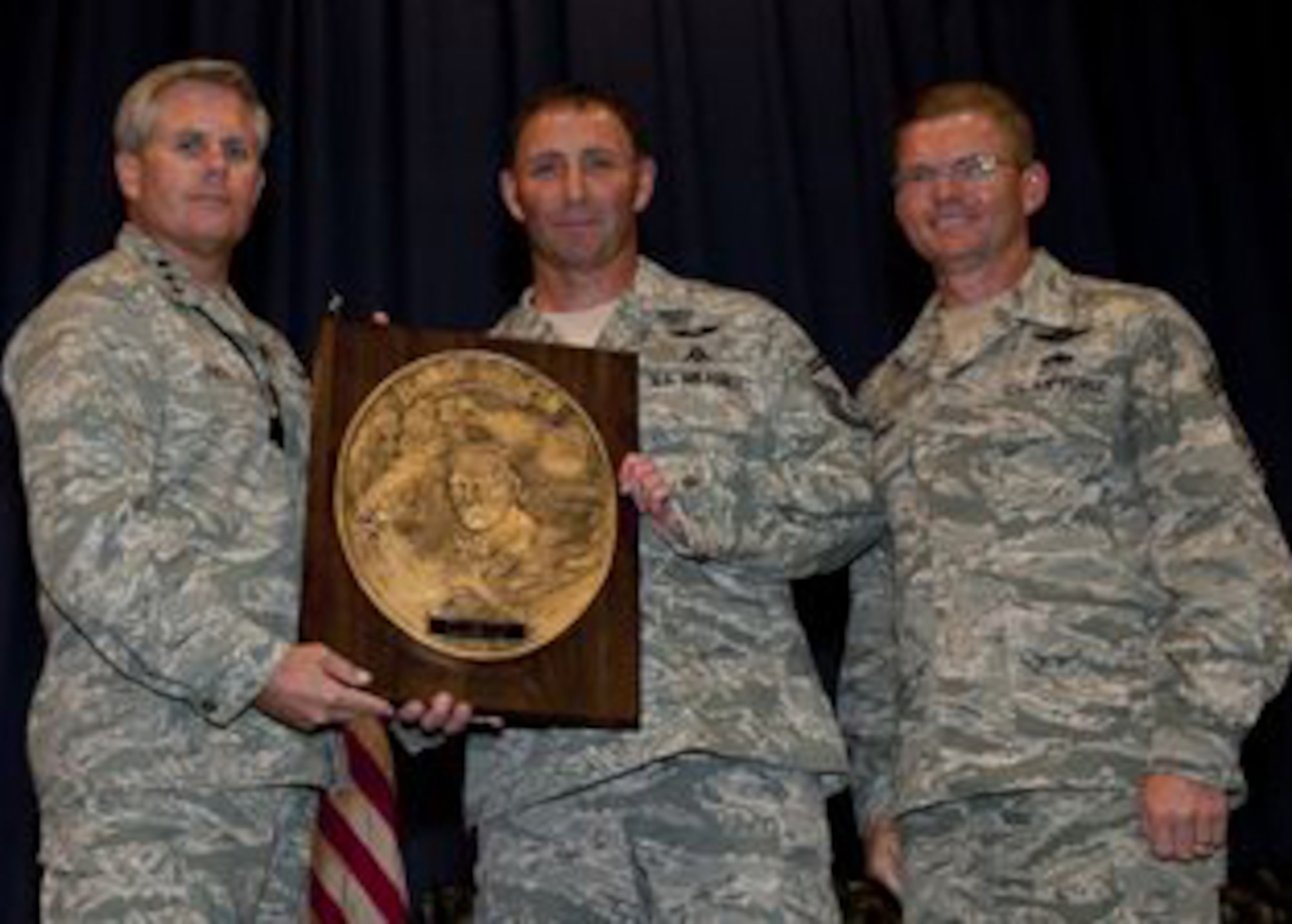 Lt. Gen. Eric Fiel, Air Force Special Operations Command commander, presents Senior Master Sgt. Davide Keaton, 720th Operations Support Squadron pararescueman, with the Sijan award at the King Auditorium on Hurlburt Field, Fla., May 22, 2013. (U.S. Air Force photo by Senior Airman Krystal M. Garrett) 