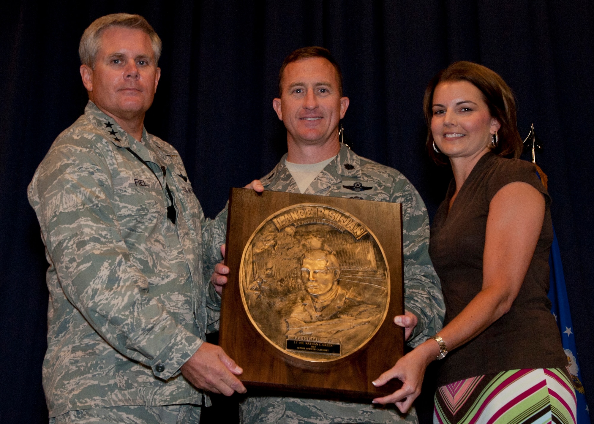 Lt. Gen. Eric Fiel, Air Force Special Operations Command commander, presents Lt. Col. Nathan Green, 4th Special Operations Squadron commander, with the Sijan award at the King Auditorium on Hurlburt Field, Fla., May 22, 2013. (U.S. Air Force photo by Senior Airman Krystal M. Garrett) 
