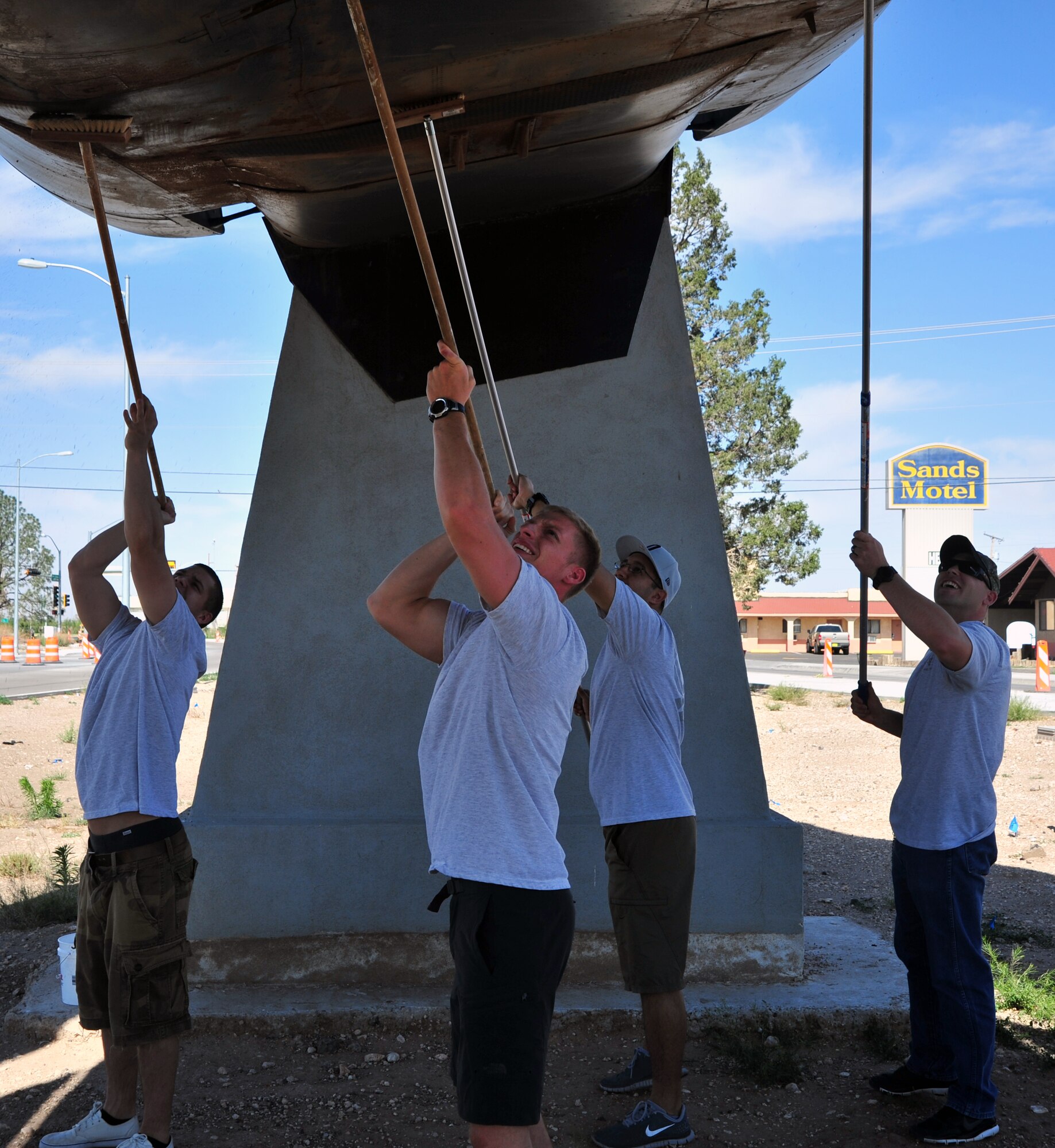 Members of the Airman Leadership School at Cannon Air Force Base, N.M., scrub an F-111 Aardvark during a community clean-up in Portales, N.M., May 18, 2013. The project was intended to foster good community relations and increase camaraderie amongst ALS students. (U.S. Air Force photo/Senior Airman Whitney Tucker)