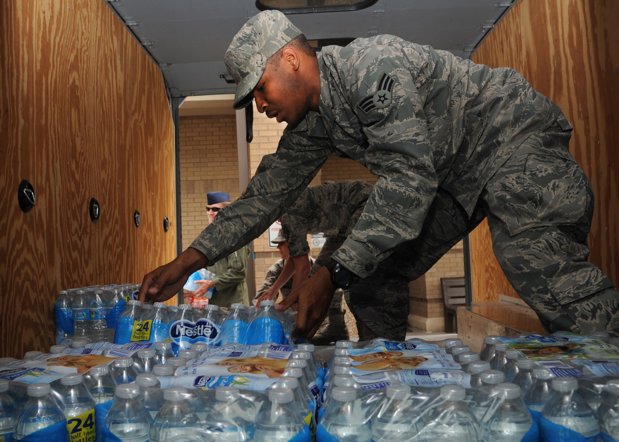 Senior Airman Mitchell Chandler, 931st Operations Support Squadron aircrew flight equipment journeyman, loads bottled water into a truck May 21, 2013, McConell Air Force Base, Kan. As of May 21, approximately $5,000 worth of basic supplies had been collected and taken to the Wichita Red Cross to support those affected by the deadly tornado that passed through Moore, Okla., May 20. (U.S. Air Force photo/Senior Airman Katrina M. Brisbin)