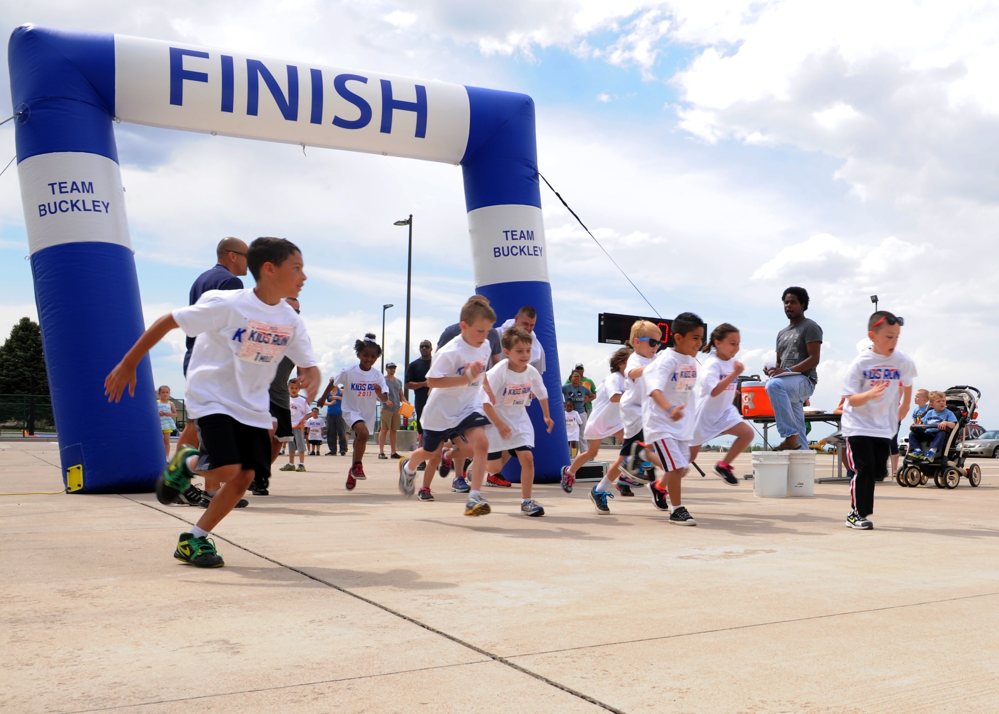 Military children begin their 1-mile run May 18, 2013, at the youth center on Buckley Air Force Base Colo. The Armed Forces Kids Run is an Air Force wide event during which parents and children can participate together. (U.S. Air Force photo by Senior Airman Marcy Glass/Released)