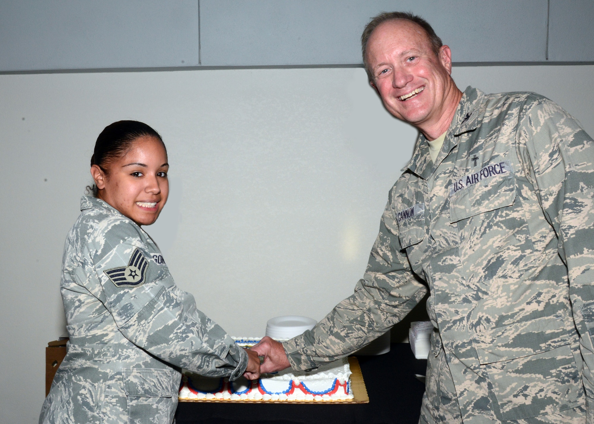 Staff Sgt. Irene Gonzales, Air Force Special Operations Command commander's support staff, and Col. Paul Cannon, AFSOC chaplain, cut AFSOC's birthday cake May 22, 2013 at Hurlburt Field, Fla. The command celebrated its 23rd birthday. (U.S. Air Force photo illustration)
