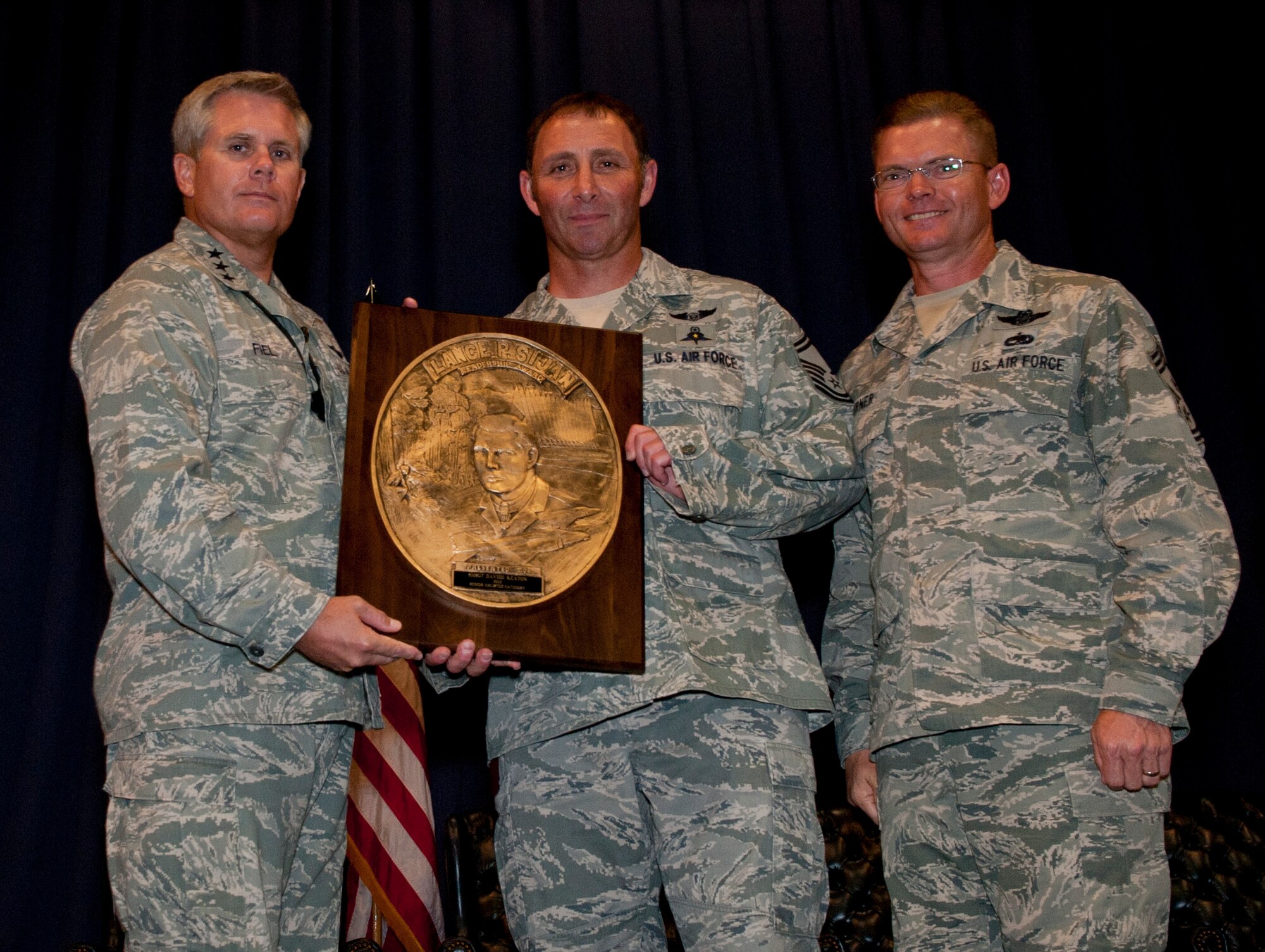 Lt. Gen. Eric Fiel, commander of Air Force Special Operations Command, presents Senior Master Sgt. Davide Keaton, superintendent of plans and programs of 24th Special Operations Wing, with the Sijan award at the King Auditorium on Hurlburt Field, Fla., May 22, 2013. The Lance P. Sijan Award, first awarded in 1981, was established in honor of the first U.S. Air Force Academy graduate to receive the Medal of Honor. (U.S. Air Force photo by Senior Airman Krystal M. Garrett) 