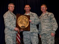Lt. Gen. Eric Fiel, commander of Air Force Special Operations Command, presents Senior Master Sgt. Davide Keaton, superintendent of plans and programs of 24th Special Operations Wing, with the Sijan award at the King Auditorium on Hurlburt Field, Fla., May 22, 2013. The Lance P. Sijan Award, first awarded in 1981, was established in honor of the first U.S. Air Force Academy graduate to receive the Medal of Honor. (U.S. Air Force photo by Senior Airman Krystal M. Garrett) 