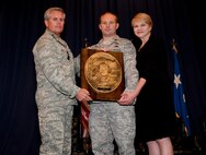 Lt. Gen. Eric Fiel, commander of Air Force Special Operations Command, presents Capt. Blake Lutrell, commander of the 21st Special Tactics Squadron with the Sijan award at the King Auditorium on Hurlburt Field, Fla., May 22, 2013. The Lance P. Sijan Award, first awarded in 1981, was established in honor of the first U.S. Air Force Academy graduate to receive the Medal of Honor. (U.S. Air Force photo by Senior Airman Krystal M. Garrett)