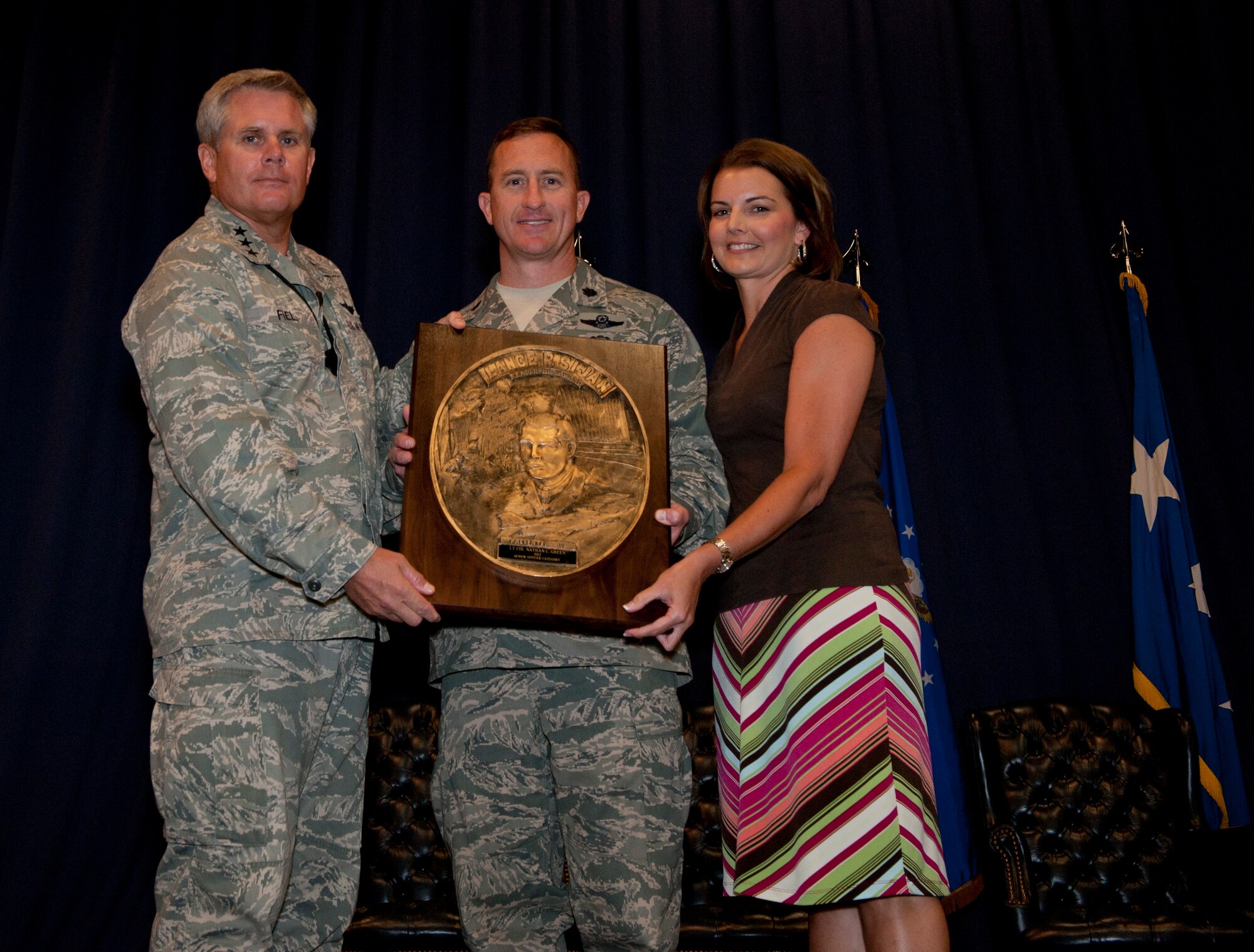 Lt. Gen. Eric Fiel, commander of Air Force Special Operations Command, presents Lt. Col. Nathan Green with the Sijan award at the King Auditorium on Hurlburt Field, Fla., May 22, 2013. The Lance P. Sijan Award, first awarded in 1981, was established in honor of the first U.S. Air Force Academy graduate to receive the Medal of Honor. (U.S. Air Force photo by Senior Airman Krystal M. Garrett)