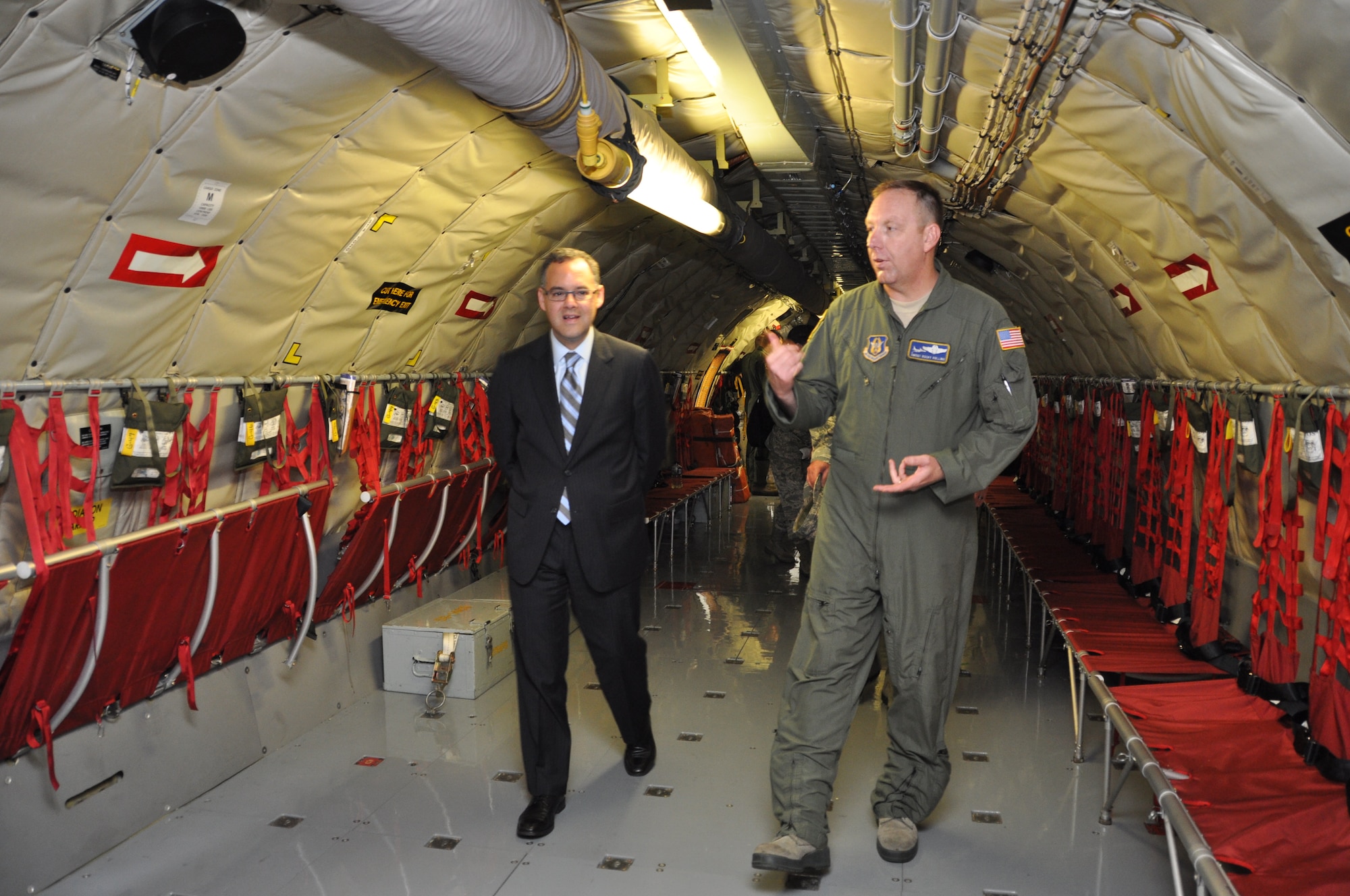 Air Force Chief Master Sgt. Frankie Rollins, a boom operator for the 756th Air Refueling Squadron, walks with Mr. Daniel Ginsberg, Assistant Secretary of the Air Force for Manpower and Reserve Affairs, Washington, D.C., inside a KC-135 Stratotanker and explains the capabilities of the aircraft during a visit to the 459th Air Refueling Wing at Joint Base Andrews, Md., May 17, 2013. Ginsberg visited the wing to interact with the Airmen and answer questions regarding manpower issues. (U.S. Air Force photo/ Staff Sgt. Katie Spencer)