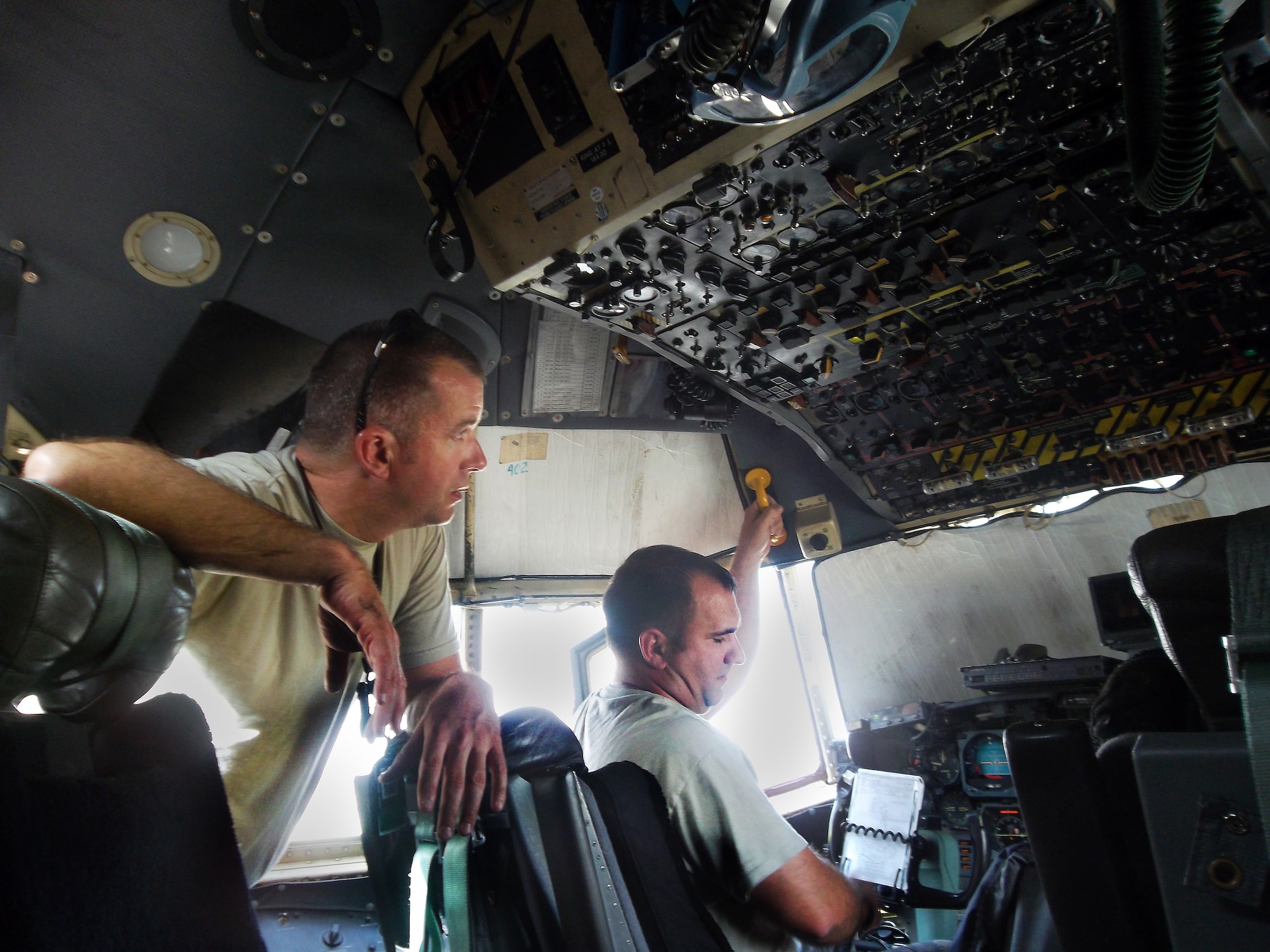 Senior Master Sgt. Marshal Sims and Tech. Sgt. Rory Lapres troubleshoot a flight deck.