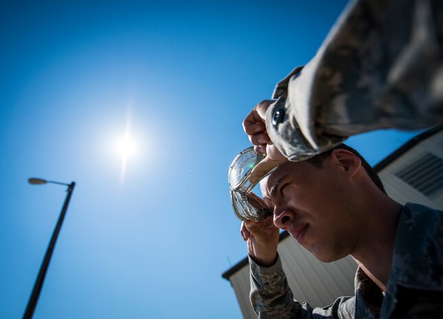 Senior Airman Dameion Johnson, 628th Logistics Readiness Squadron Fuels specialist, dons his safety goggles before working with Jet fuel May 9, 2013, at Joint Base Charleston –Air Base, S.C. All fuels specialist are required to wear rubber gloves, an apron and goggles when handling fuel. (U.S. Air Force photo/ Senior Airman Dennis Sloan)