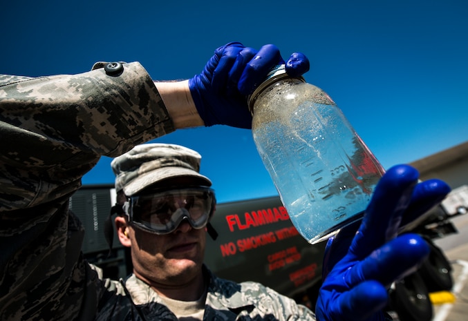 Senior Airman Mark Miller, 628th Logistics Readiness Squadron Fuels Laboratory technician, checks a jar of Jet fuel from an R-11 Truck for water and sediments May 9, 2013, at Joint Base Charleston – Air Base, S.C. Since fuel is lighter than water the two separate during this test while sediments gather in the middle. (U.S. Air Force photo/ Senior Airman Dennis Sloan)