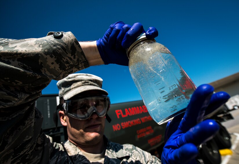 Senior Airman Mark Miller, 628th Logistics Readiness Squadron Fuels Laboratory technician, checks a jar of Jet fuel from an R-11 Truck for water and sediments May 9, 2013, at Joint Base Charleston – Air Base, S.C. Since fuel is lighter than water the two separate during this test while sediments gather in the middle. (U.S. Air Force photo/ Senior Airman Dennis Sloan)