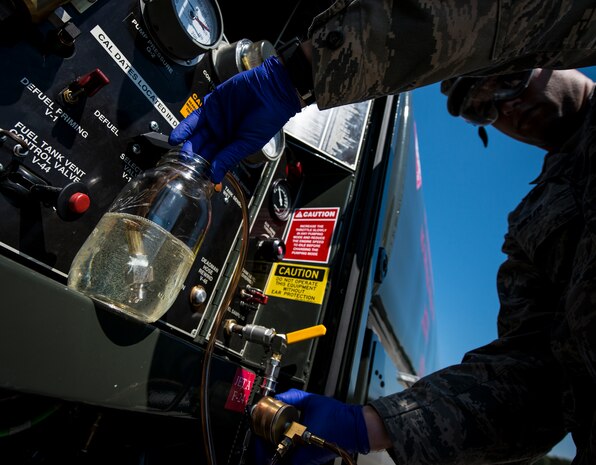 Senior Airman Mark Miller, 628th Logistics Readiness Squadron Fuels Laboratory technician, transfers Jet fuel from an R-11 Truck to be used in a visual test May 9, 2013, at Joint Base Charleston – Air Base, S.C. The test reveals if there is water or sediments in the fuel. (U.S. Air Force photo/ Senior Airman Dennis Sloan)