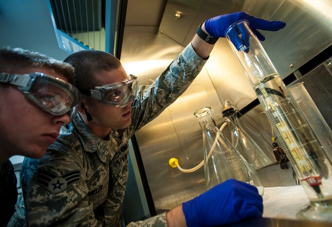 Senior Airmen Mark Miller and Airman 1st Class Chaz Wise, 628th Logistics Readiness Squadron Fuels technicians, use a hydrometer to perform an API Gravity test on Jet fuel May 9, 2013, at Joint Base Charleston – Air Base, S.C. The hydrometer floats when the fuel is at 60 degrees Fahrenheit. Since fuel expands and contracts when exposed to hot and cold temperatures, the API Gravity test can provide Airmen with the accurate number of gallons in a fuel tank depending on the outside temperature. (U.S. Air Force photo/ Senior Airman Dennis Sloan)