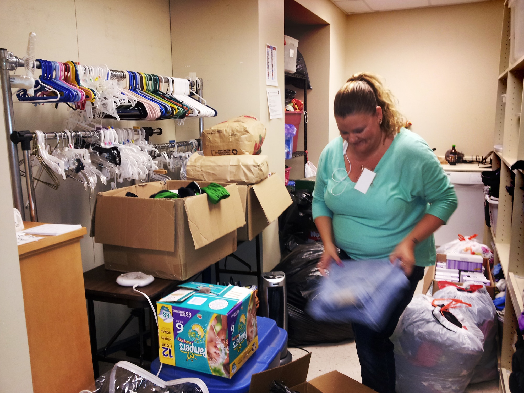 Andrea Collins sorts and folds donations in the Airman's Attic at Tinker Air Force Base. The center is normally open only to active duty military in need of assistance but is now open to any member of Team Tinker who has been affected by the tornado that tore through nearby Moore, Okla. (Air Force photo by Micah Garbarino)