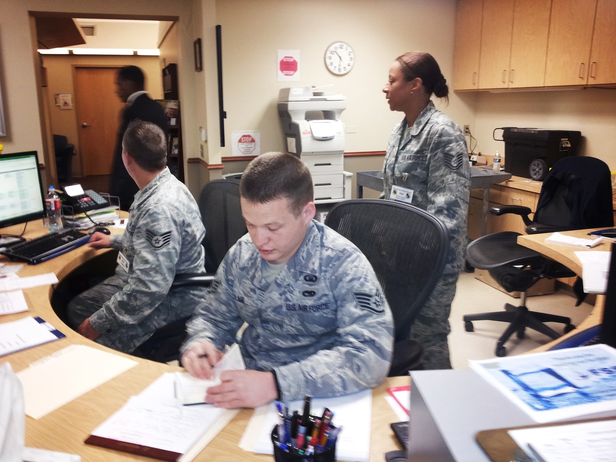 From left, Staff Sgt Jesse Moen, Mr. Rickie Smith, Staff Sgt. Samuel Lollar and Tech Sgt. Nella Nixon man the phones at the Emergency Family Readiness Center at TInker Air Force Base after an F5 tornado tore through the nearby town of Moore leaving more than 340 military and civilian members of Team Tinker without homes or temporarily displaced.  (Air Force photo by Micah Garbarino)