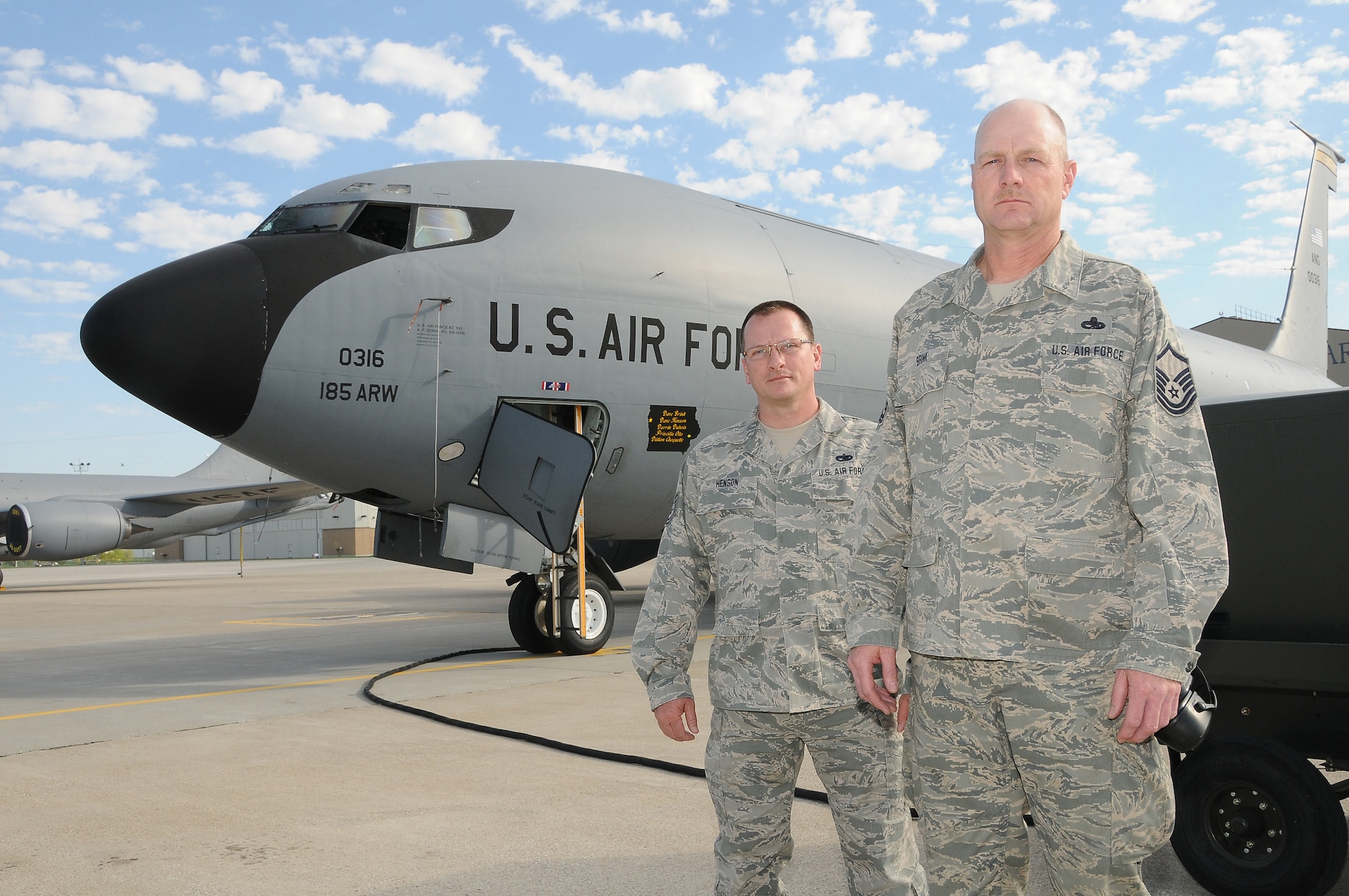 Master Sgt. Dave Brink (right) and Technical Sgt. Dave Henson (left) are on the ramp area at the Air Guard facility in Sioux City, Iowa. The two airmen are assigned as the crew chiefs of the KC-135R pictured with them.  This tail number 60-0316 dubbed “Raider Nation” has been assigned to the 185th Air Refueling Wing Iowa Air National Guard since 2007. The KC-135 will soon be transferred to the Utah Air National Guard.
U.S. Air Guard Photo by: Master Sgt. Vincent De Groot /released