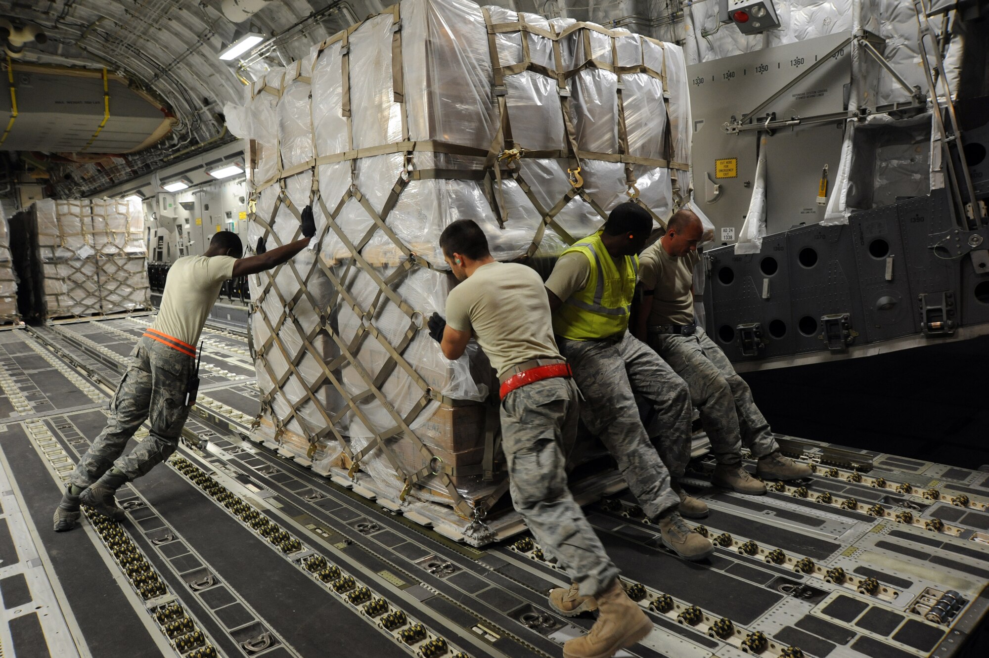 Airman from the 386th Air Expeditionary Logistics Readiness Squadron load pallets of non-lethal aid bound for the Syrian Opposition Coalition on to a Travis Air Force Base, Calif., based C-17 Globemaster III, at an undisclosed base in Southwest Asia, May 21, 2013. (U.S. Air Force photo/Senior Master Sgt. George Thompson)