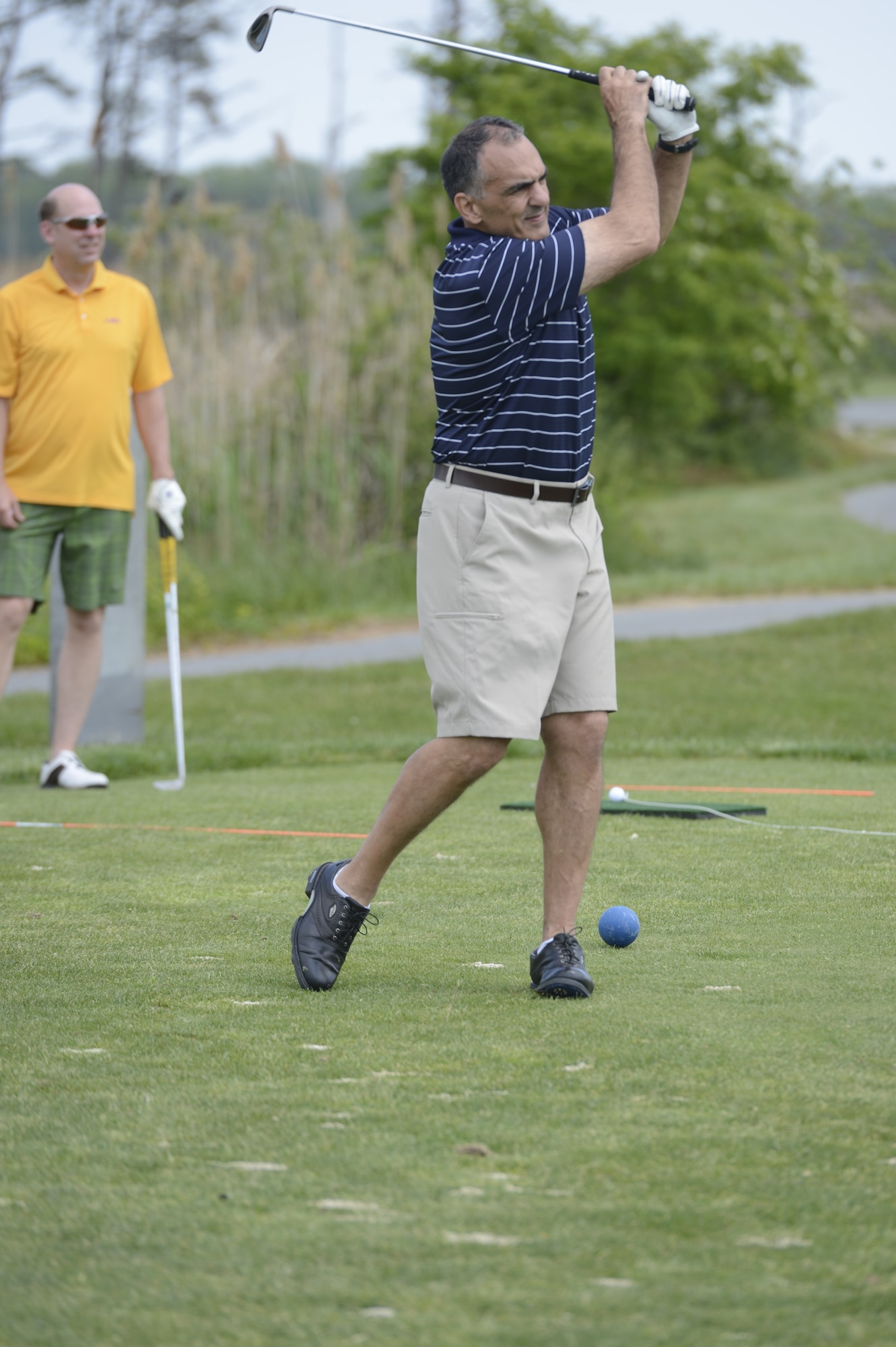 Mr. Mike Tatoian, Executive Vice Preseident and Chief Operating Officer of Dover Motorsports, Incorporated, watches his golf ball fly toward the 3rd hole at Jonathon's Landing Golf Course, near Dover Air Force Base, Del. on May 15th, 2013. Key military leaders from Dover AFB were paired with local civic and business leaders, like Mr. Tatoian, for the Bluesuiters Golf Tournament as part of Dover's robust community outreach program. (U.S. Air Force photo/Greg L. Davis)
