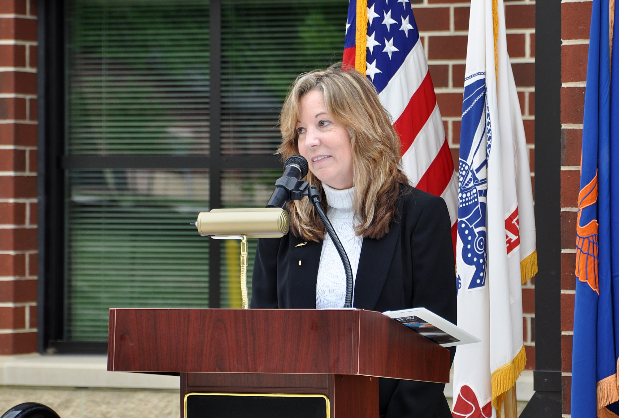 Penny Jackson, daughter-in-law of retired U.S. Army Command Sgt. Maj. Richard Lee Jackson, thanks the audience during the Jackson Hall dedication ceremony at Fort Eustis, Va., May 21, 2013. Jackson, who served 29 years in uniform and 24 additional years as an Army civilian, was instrumental in the creation of the U.S. Army Aviation Logistics School, the predecessor to 128th Aviation Brigade. (U.S. Air Force photo by Tech. Sgt. April Wickes/Released)